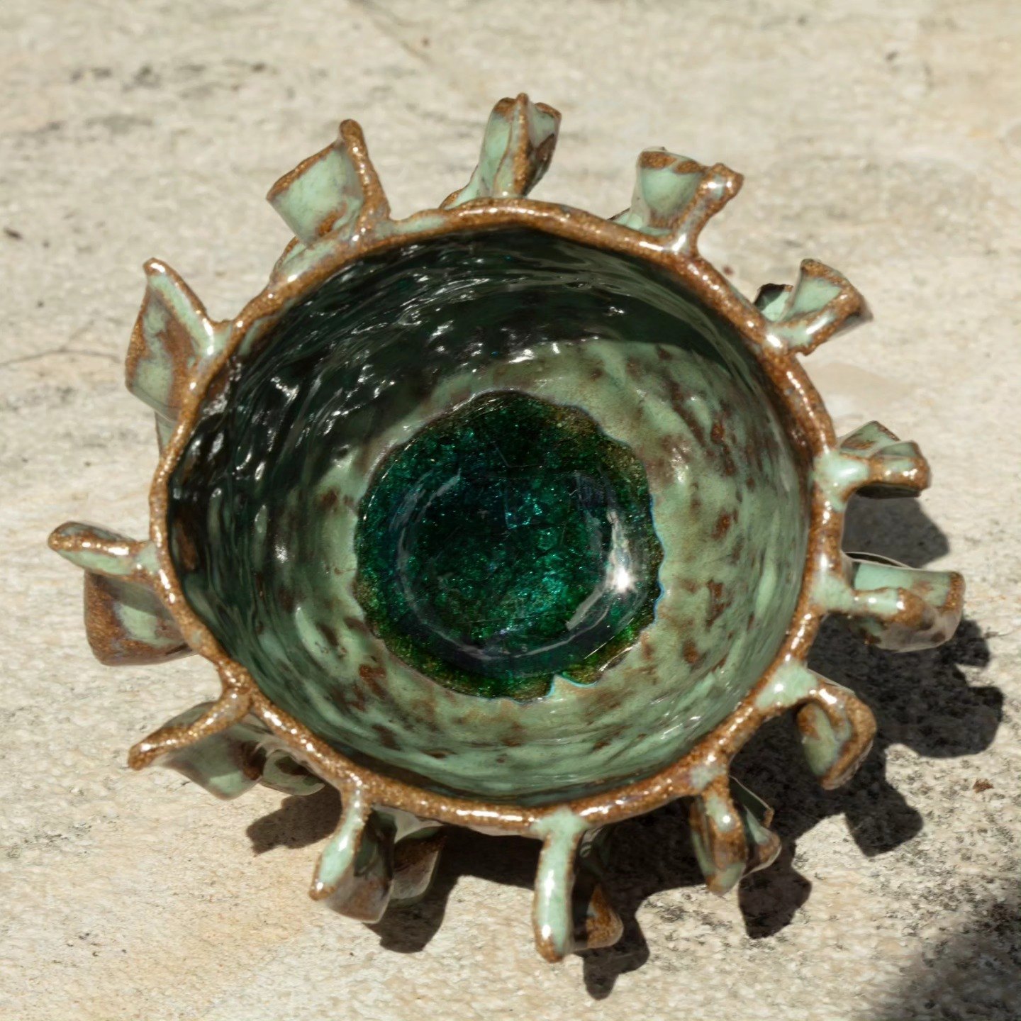 Spiky green and brown glazed ceramic bowl