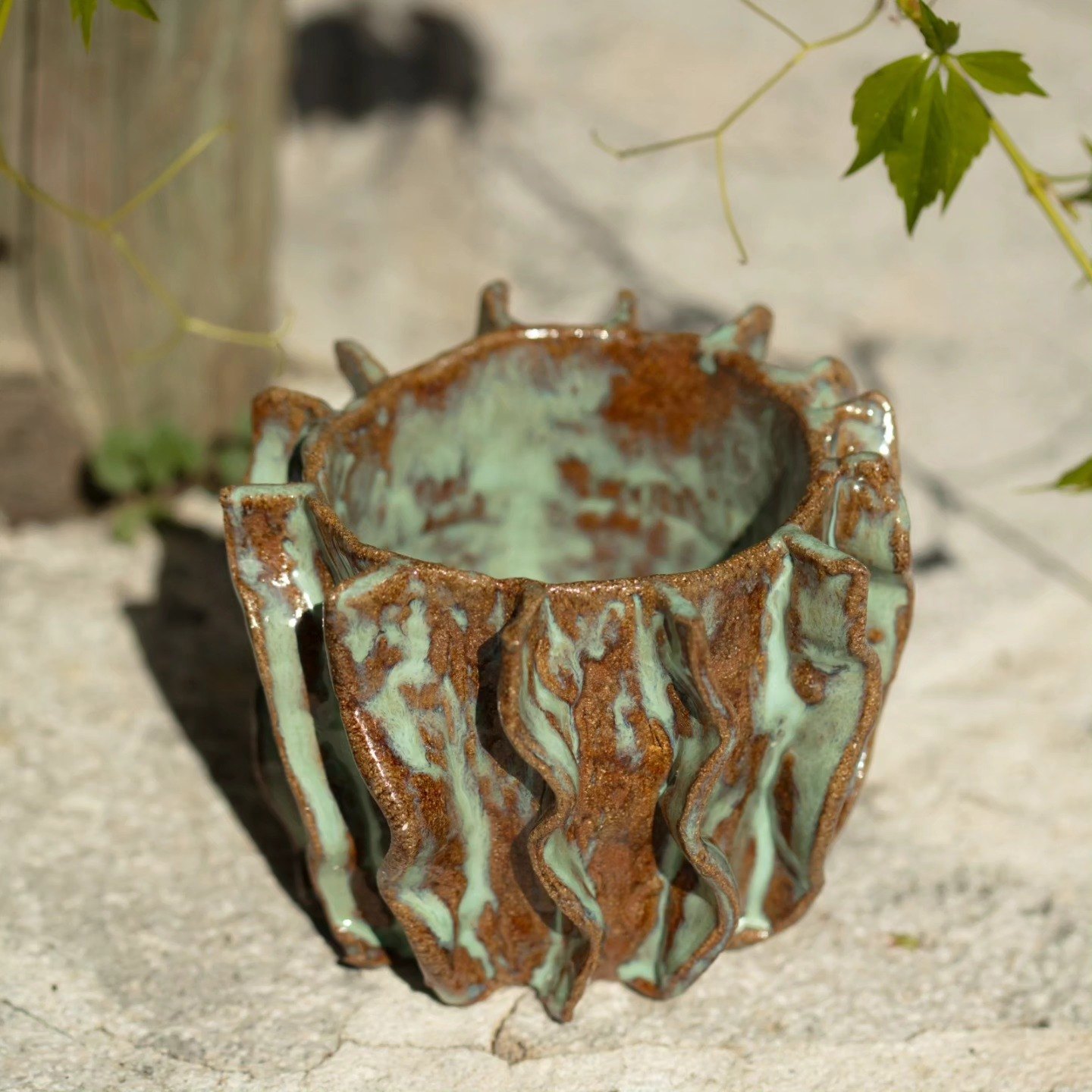 Ridged brown and green glazed ceramic vessel