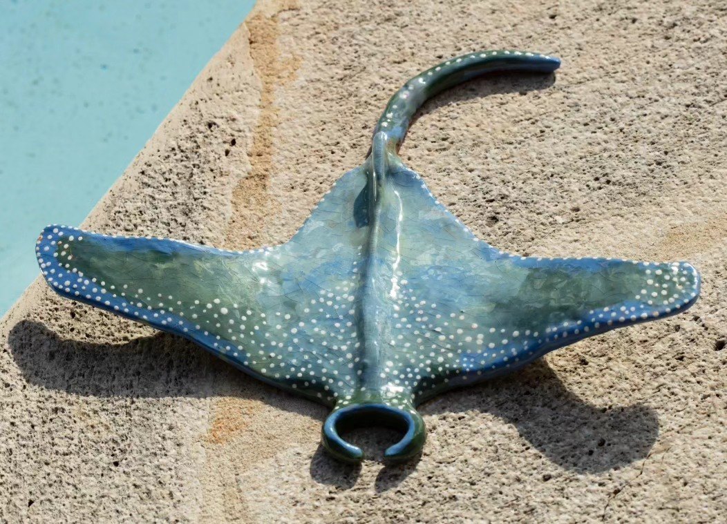 Blue-green glazed ceramic sculpture of a stingray