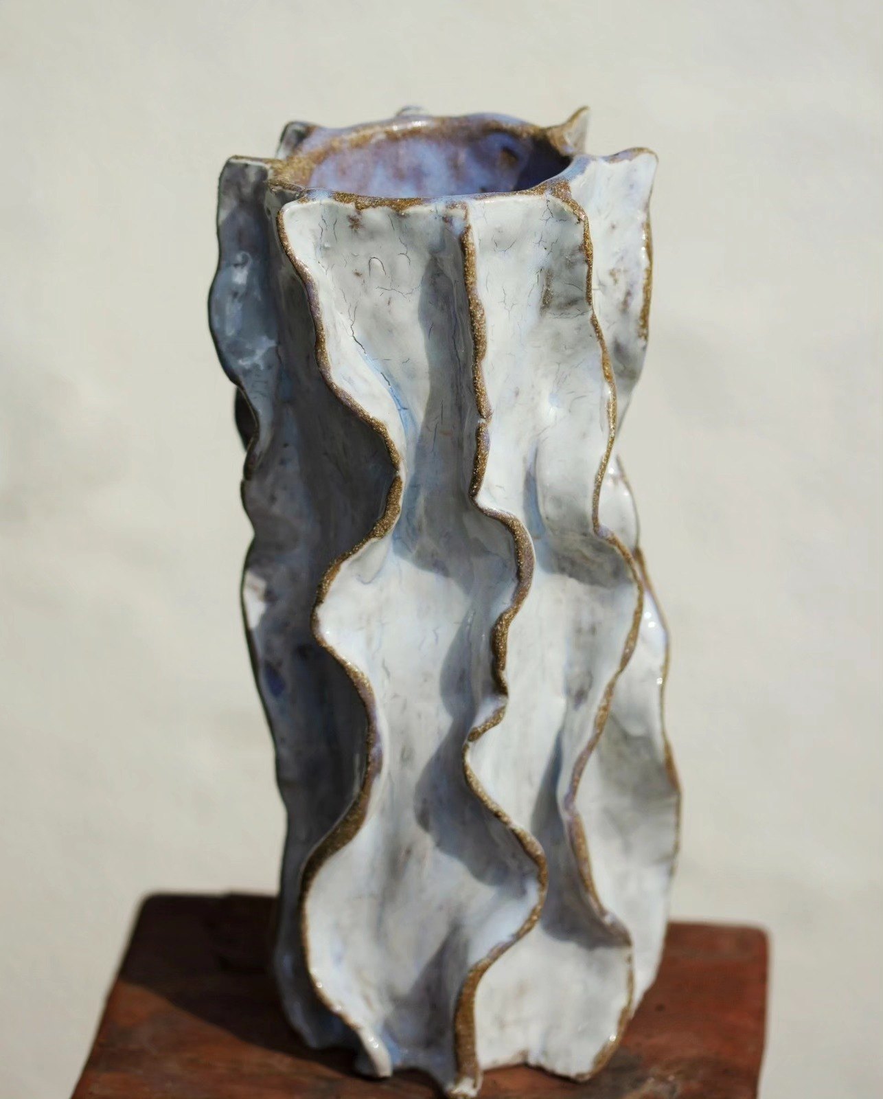 Tall wavy white and blue glazed ceramic vase